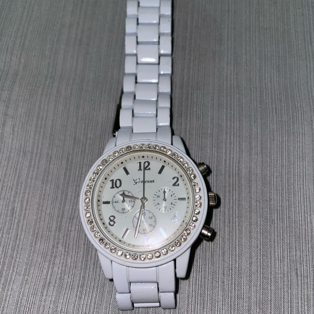 White Geneva watch with stones around the edge of the face